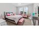 This cute bedroom features a large bed, pink couch, and a vanity at 2724 Coco Palm Cir, Wesley Chapel, FL 33543