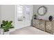 Bright foyer featuring decorative glass front doors, console table with a mirror, and a potted plant at 2724 Coco Palm Cir, Wesley Chapel, FL 33543