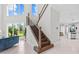 Bright foyer with staircase, views of the living room, and an open concept kitchen at 2724 Coco Palm Cir, Wesley Chapel, FL 33543