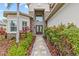 Inviting front entrance with double doors, stone accents, and lush landscaping creates an appealing curb appeal at 2724 Coco Palm Cir, Wesley Chapel, FL 33543