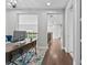 This home features a second floor hallway with wood floors, modern railing and lots of light at 2724 Coco Palm Cir, Wesley Chapel, FL 33543