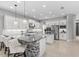 Bright kitchen featuring a large island, white cabinets, and stainless steel appliances at 2724 Coco Palm Cir, Wesley Chapel, FL 33543
