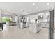 Spacious open-concept kitchen with white cabinets, granite countertops, and modern appliances at 2724 Coco Palm Cir, Wesley Chapel, FL 33543
