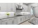 Bright kitchen featuring white cabinets, granite countertops and stainless steel hood at 2724 Coco Palm Cir, Wesley Chapel, FL 33543