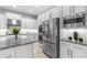 Modern kitchen featuring stainless steel appliances, granite countertops and white cabinetry at 2724 Coco Palm Cir, Wesley Chapel, FL 33543