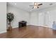 Open living room featuring hardwood floors and a piano with a ceiling fan at 2724 Coco Palm Cir, Wesley Chapel, FL 33543