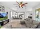 Spacious living room with ceiling fan, tile floor, and open to kitchen and dining at 2724 Coco Palm Cir, Wesley Chapel, FL 33543