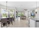 Open-concept living space featuring tile floors, modern furnishings, and sliding glass doors to the outdoor area at 2724 Coco Palm Cir, Wesley Chapel, FL 33543