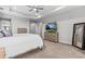 Spacious main bedroom with tray ceiling, TV, and neutral decor at 2724 Coco Palm Cir, Wesley Chapel, FL 33543