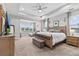 Spacious main bedroom featuring a tray ceiling, sitting area and large windows at 2724 Coco Palm Cir, Wesley Chapel, FL 33543