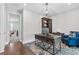 This is a stylish office space with wood floors, large desk, and a comfortable blue chair at 2724 Coco Palm Cir, Wesley Chapel, FL 33543