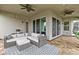 This patio features ceiling fans, and outdoor furniture for entertaining at 2724 Coco Palm Cir, Wesley Chapel, FL 33543