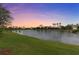 Scenic view of the pond at sunset surrounded by lush greenery, offering a tranquil and serene setting at 2724 Coco Palm Cir, Wesley Chapel, FL 33543