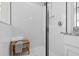 Bright bathroom shower featuring a wooden bench and full tile surround at 2724 Coco Palm Cir, Wesley Chapel, FL 33543