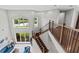 View from the landing of the staircase, including the living room with lake views at 2724 Coco Palm Cir, Wesley Chapel, FL 33543