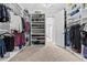 Bright walk-in closet with custom storage solutions, shelving, and carpeted flooring at 2724 Coco Palm Cir, Wesley Chapel, FL 33543