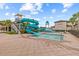 Community water park with blue waterslides and splash pads for Gathering fun in the sun at 2724 Coco Palm Cir, Wesley Chapel, FL 33543