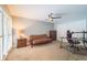 Cozy bedroom features natural light, a ceiling fan, a futon, and carpet flooring at 3005 Wilton Ln, Valrico, FL 33596
