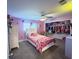 Charming pink bedroom featuring a comfortable bed, ample closet space, and playful decor at 3005 Wilton Ln, Valrico, FL 33596