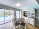 Bright dining area with pool view, modern table set, and stylish hutch at 3005 Wilton Ln, Valrico, FL 33596