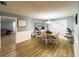 Bright dining room with hardwood floors, modern chandelier, and large windows, perfect for Gathering meals at 3005 Wilton Ln, Valrico, FL 33596