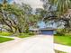Charming single-story home with mature trees, a well-manicured lawn, and a spacious two-car garage at 3005 Wilton Ln, Valrico, FL 33596