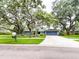 Quaint single-story home with a well-kept lawn, mature trees, and a two-car garage, offering curb appeal at 3005 Wilton Ln, Valrico, FL 33596