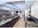 Open-concept kitchen with granite countertops, stainless steel appliances, and seamless flow to living area at 3005 Wilton Ln, Valrico, FL 33596