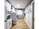 Functional laundry room with modern appliances, storage cabinets, and a convenient utility sink at 3005 Wilton Ln, Valrico, FL 33596