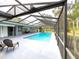 Screened-in pool with a covered lanai, outdoor seating, and lush landscaping at 3005 Wilton Ln, Valrico, FL 33596