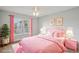 Charming bedroom with pink accents, featuring a cozy bed, window, and stylish decor, creating a comfortable retreat at 3121 Egret Ter, Safety Harbor, FL 34695