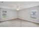 Spacious bedroom with two windows offering natural light and a ceiling fan for added comfort at 3121 Egret Ter, Safety Harbor, FL 34695