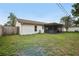 Backyard of home with well-maintained lawn and a screened patio with a hot tub at 3121 Egret Ter, Safety Harbor, FL 34695