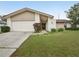 Charming single-story home with well-maintained lawn, garage, and neutral color scheme at 3121 Egret Ter, Safety Harbor, FL 34695