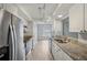 Bright kitchen with stainless steel appliances, granite countertops, white cabinetry, and ample counter space for cooking at 3121 Egret Ter, Safety Harbor, FL 34695
