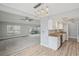 Open-concept kitchen boasts granite countertops, white cabinets, and stainless steel appliances, seamlessly connecting to the living space at 3121 Egret Ter, Safety Harbor, FL 34695