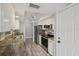 Well-lit kitchen with stainless steel appliances, granite countertops and white cabinets, providing a functional and appealing cooking space at 3121 Egret Ter, Safety Harbor, FL 34695