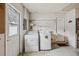A laundry room features a washer, a dryer, cabinets and a utility sink at 3121 Egret Ter, Safety Harbor, FL 34695