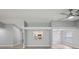 Large living room showcasing light-colored flooring, fan, and kitchen peek-through at 3121 Egret Ter, Safety Harbor, FL 34695