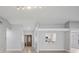 Bright living space with light-colored walls and floors, stylish door, and kitchen views at 3121 Egret Ter, Safety Harbor, FL 34695