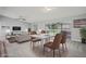 Staged living and dining room with neutral colors and an outside view at 3121 Egret Ter, Safety Harbor, FL 34695