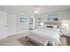 Staged main bedroom featuring contemporary decor, paintings, bench and ensuite bathroom at 3121 Egret Ter, Safety Harbor, FL 34695