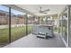 A screened patio features a hot tub, and a ceiling fan at 3121 Egret Ter, Safety Harbor, FL 34695