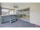 Relaxing covered patio with a ceiling fan and a hot tub, accessible through sliding glass doors at 3121 Egret Ter, Safety Harbor, FL 34695