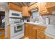 Well-lit kitchen features wooden cabinets, laminate countertops, modern appliances, and stainless steel sink at 35152 Dodie, Zephyrhills, FL 33541