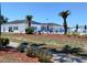 Community clubhouse with a pool surrounded by mulch, shrubbery, and palm trees at 35152 Dodie, Zephyrhills, FL 33541