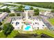 Overhead view of apartment complex showcasing a swimming pool and proximity to a tranquil pond at 3802 Cortez Cir # D, Tampa, FL 33614