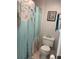 Compact bathroom with floral shower curtain and white toilet at 3802 Cortez Cir # D, Tampa, FL 33614