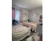 Charming bedroom featuring two twin beds, adorned with colorful bedding and delightful decor, creating a cozy and inviting atmosphere at 3802 Cortez Cir # D, Tampa, FL 33614
