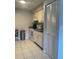 Kitchen with white appliances, tile flooring and closet with bi-fold doors at 3802 Cortez Cir # D, Tampa, FL 33614